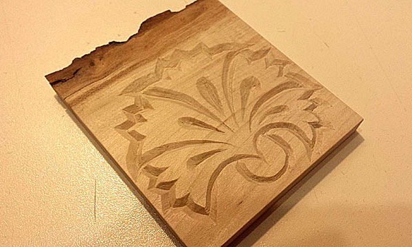 Small hand carved carnation wall decoration