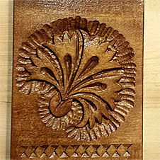 Small hand carved carnation wall decoration with carved laced